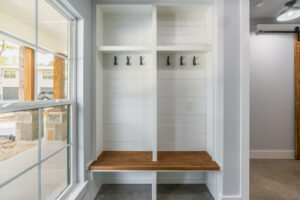Custom home built-in shelving and storage for drop zone entry