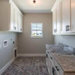 Custom Laundry Room with counter space and storage - Larue Custom Homes