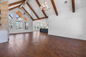 Great room living room with exposed beams - FM 275 new house built by LaRue Custom Homes