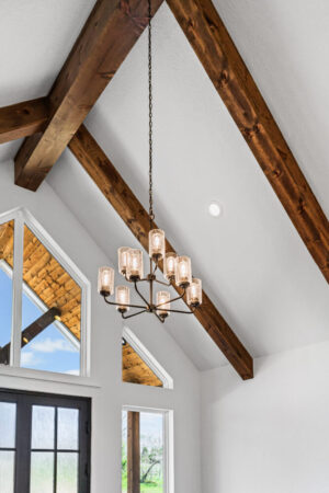 Luxury lighting in living room with exposed beams - FM 275 new house built by LaRue Custom Homes
