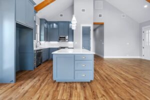 Custom kitchen featuring blue cabinets and pendant light fixtures